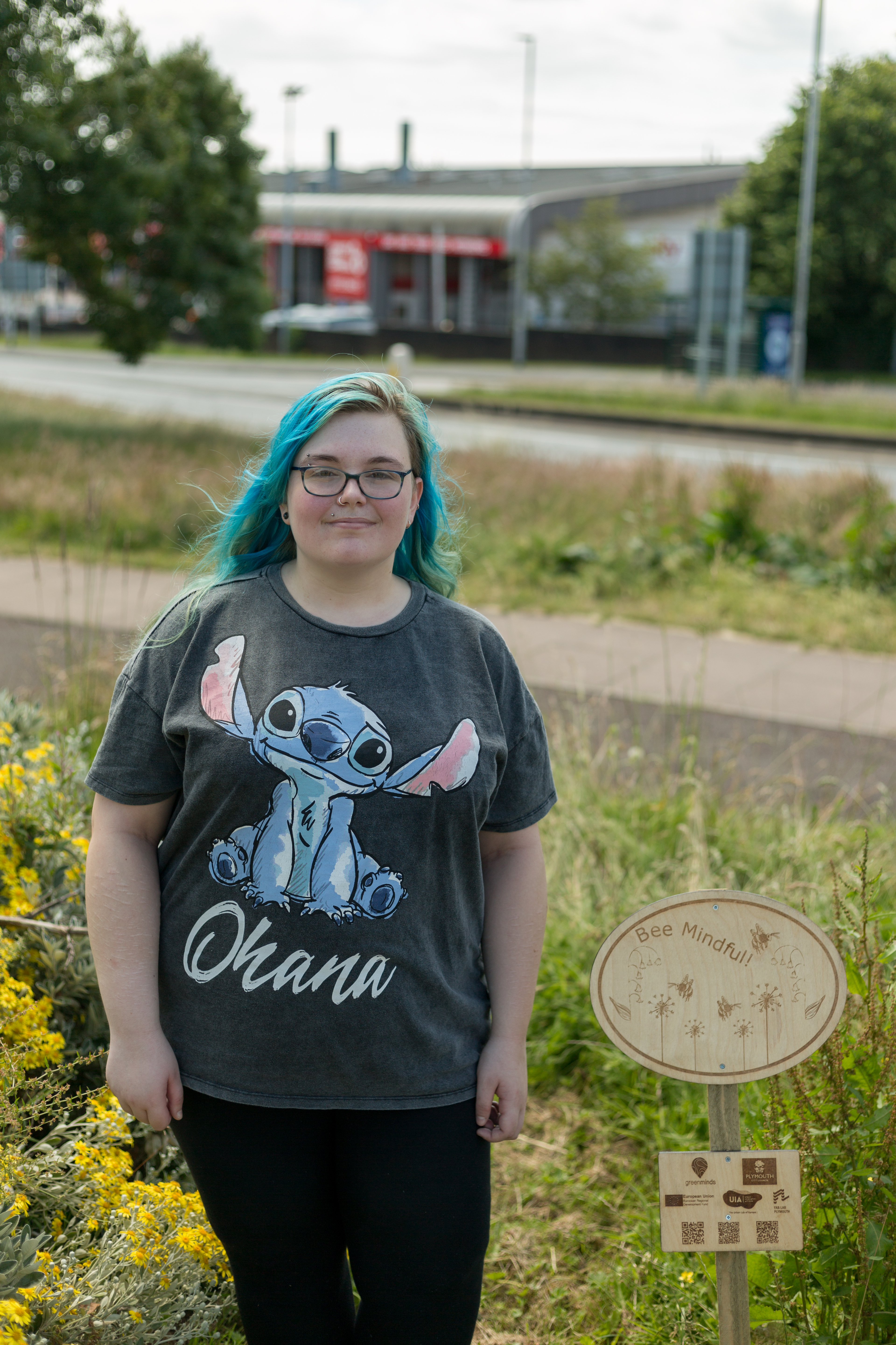 Bethan Price Nicholls with their wildflower meadow sign Image Credit Ray Goodwin